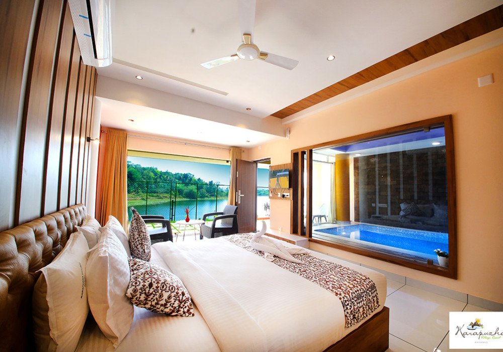 Pool villa bedroom with lake view at Karapuzha Village Resort
